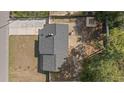 Aerial view of the house showing the roof, patio, fire pit, and surrounding trees at 4048 Sandtrap Ave., Little River, SC 29566