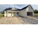 A quaint single-story home featuring a welcoming covered porch and an attached garage at 6049 Hodges Rd., Conway, SC 29527