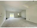 Large living room with neutral walls, base trim, backyard view and natural light at 6049 Hodges Rd., Conway, SC 29527