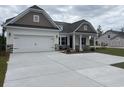 Stylish home features a spacious two-car garage and a meticulously maintained front yard at 7059 Shady Grove Rd., Conway, SC 29527