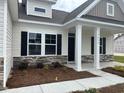This house has a welcoming front porch and an exterior that combines stone and siding at 7059 Shady Grove Rd., Conway, SC 29527