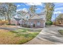 Brick home features a long driveway, and mature trees at 710 Cedar Dr. S, Surfside Beach, SC 29575