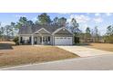 Charming single-story home features a well-manicured lawn, two-car garage and inviting front porch at 825 Payne Ct., Conway, SC 29526