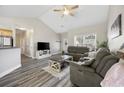 Bright living room with vaulted ceilings, gray wood floors, and comfortable seating at 825 Payne Ct., Conway, SC 29526