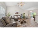 Bright living room with vaulted ceilings, hardwood floors, and comfortable seating, creating a welcoming atmosphere at 825 Payne Ct., Conway, SC 29526