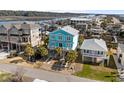 An aerial view showcasing the beautiful blue coastal home and its prime location at 84 Wilmington St., Ocean Isle Beach, NC 28469