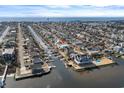 Wide aerial view showcasing the neighborhood, coastal home, and waterway access at 84 Wilmington St., Ocean Isle Beach, NC 28469