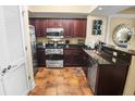 Well-equipped kitchen featuring stainless steel appliances, granite countertops, and dark wood cabinetry at 100 North Beach Blvd. # 1917, North Myrtle Beach, SC 29582