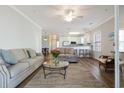 Bright living room featuring neutral furniture, ceiling fan, and an open floor plan at 178 Clubhouse Dr. # 3, Sunset Beach, NC 28468