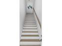 Bright stairway with white risers, wood treads, and wooden handrail at 2306 Seaseeker Ln., Myrtle Beach, SC 29577