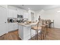 Well-lit kitchen features an island with bar stool seating, stainless appliances, and white cabinetry at 2602 Blue Crane Circle # 104, Myrtle Beach, SC 29577