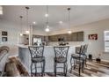 Kitchen with a breakfast bar, pendant lights, bar stools, gray cabinets, and stainless steel appliances at 269 Leste Rd., Myrtle Beach, SC 29588