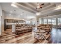 Spacious living room with hardwood floors, a tray ceiling with recessed lights, and open access to the kitchen at 269 Leste Rd., Myrtle Beach, SC 29588