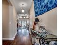 Inviting hallway with hardwood floors, elegant decor, and a glimpse into the sunlit living area at 2749 Sanctuary Blvd., Conway, SC 29526