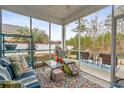 Relaxing screened-in porch with comfortable seating and views of the backyard at 313 Foxpath Loop, Myrtle Beach, SC 29588