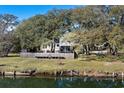 Backyard view with a wooden fence next to a waterway at 315 Oak Dr. N, Surfside Beach, SC 29575