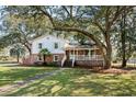 Charming two-story home featuring a brick foundation and a welcoming front porch at 315 Oak Dr. N, Surfside Beach, SC 29575