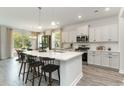 Modern open-concept kitchen with white cabinets, quartz countertops, and a large island at 543 Slaty Dr., Myrtle Beach, SC 29588