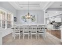 Elegant dining room with a large table, stylish lighting, and views of the backyard, perfect for entertaining at 5508 Leatherleaf Dr., North Myrtle Beach, SC 29582