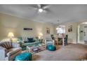 Open-concept living room with ample seating, stylish decor, and seamless flow to dining area at 5750 Oyster Catcher Dr. # 522, North Myrtle Beach, SC 29582