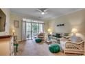 Comfortable living room with cozy seating, decorative pillows, and access to a balcony at 5750 Oyster Catcher Dr. # 522, North Myrtle Beach, SC 29582