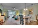 Bright living room with plush seating, decorative rug, and sliding glass door to balcony at 5750 Oyster Catcher Dr. # 522, North Myrtle Beach, SC 29582