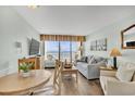 Bright living area with coastal decor, plush seating, and balcony access at 6804 N Ocean Blvd. # 533, Myrtle Beach, SC 29572