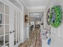 Inviting foyer with wood flooring, white trim, french doors, and stylish decor setting a welcoming tone at 1118 Prescott Circle, Myrtle Beach, SC 29577