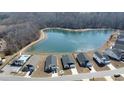 Aerial view of lakeside community with a pond, swimming pool, and modern homes at 325 High Falls Dr., Conway, SC 29526