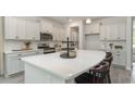 Bright kitchen featuring white cabinetry, a large island, and modern stainless steel appliances at 358 Glacier Way, Conway, SC 29526