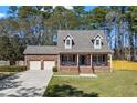 Beautiful two-story brick home with a well-manicured lawn and inviting front porch at 4350 Goude St., Murrells Inlet, SC 29576