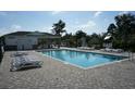 Community pool with tables, chairs, and well-manicured landscaping, providing a resort-like experience for residents at 439 Lifestyle Court, Surfside Beach, SC 29575