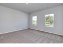 Bright, carpeted bedroom with two large windows offering plenty of natural light at 491 Wagner Cir., Conway, SC 29526