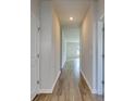 Hallway features wood-look floors leading to a bright living area with natural light at 491 Wagner Cir., Conway, SC 29526