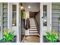 Warm entryway with a decorative front door, elegant rug, and staircase leading to upper floors at 5137 Highway 17 Business # 3A, Murrells Inlet, SC 29576