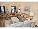 Bright living room featuring neutral walls, hardwood floors, and comfortable furnishings at 517 Brooksher Dr., Myrtle Beach, SC 29588