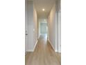 Bright hallway with light wood floors, fresh paint, and recessed lighting at 620 Mccorkle Place, Conway, SC 29526