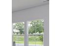 A view from inside the home through the double windows to the green backyard at 620 Mccorkle Place, Conway, SC 29526