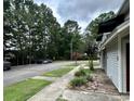 Exterior view of a street with condominiums and sidewalks, surrounded by mature trees at 801 Burcale Rd. # G-5, Myrtle Beach, SC 29579