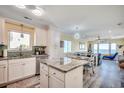 Sun-filled kitchen with stainless appliances flows into an open concept living and dining area with ocean views at 1417 S Ocean Blvd. # 202, Surfside Beach, SC 29575