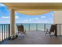 Inviting balcony with chairs providing stunning views of the ocean and beach at 1425 S Ocean Blvd. # 7C, North Myrtle Beach, SC 29582