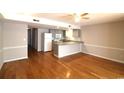 Open concept living space with hardwood floors flowing into the kitchen with granite countertops at 1500 Deer Creek Rd. # C, Surfside Beach, SC 29575