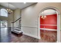 Spacious foyer showcasing hardwood floors, staircase with white railing, and archway leading to dining room at 1585 Brookgreen Dr., Myrtle Beach, SC 29577