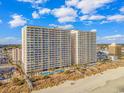 Aerial view of a beachfront condo building with a pool and beach access at 1625 S Ocean Blvd. # 1810, North Myrtle Beach, SC 29582