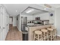 Galley kitchen featuring stainless appliances, granite counters, and breakfast bar seating at 1625 S Ocean Blvd. # 1810, North Myrtle Beach, SC 29582