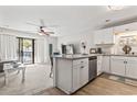 Bright kitchen featuring white cabinets, stainless steel appliances, and granite countertops overlooking the living area at 1891 Colony Dr. # 15-G, Surfside Beach, SC 29575