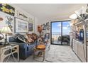 Cozy condo living room with ocean view balcony and colorful eclectic decor at 2001 S Ocean Blvd. # 209, Myrtle Beach, SC 29577