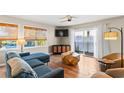 Comfortable living room with natural light, featuring a blue sofa, wood coffee table, and stylish furnishings at 27 Ocean Isle West Blvd., Ocean Isle Beach, NC 28469