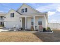 Beautiful home featuring a cozy front porch with chairs, enhancing curb appeal at 360 Cattle Drive Circle, Myrtle Beach, SC 29588