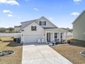 Attractive home with a two-car garage, manicured lawn, and welcoming front porch at 360 Cattle Drive Circle, Myrtle Beach, SC 29588